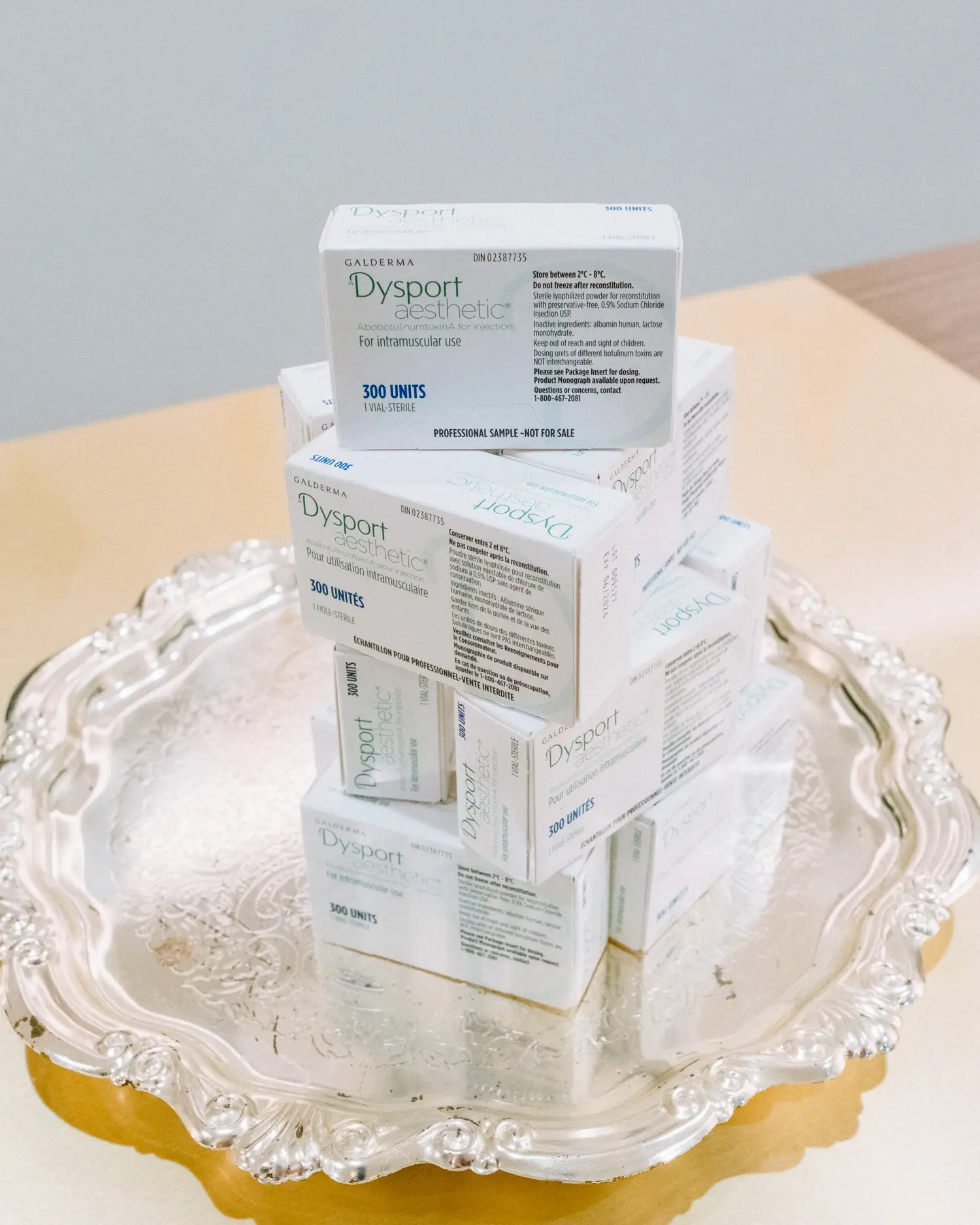 Boxes of injectable neuromodulator stacked on a silver tray at Vigée Dental